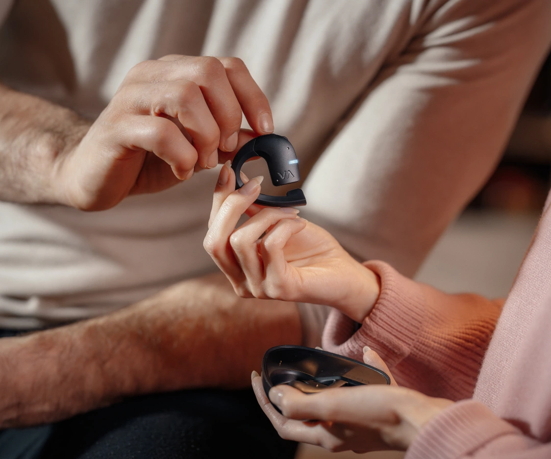 couple sharing translating earbuds